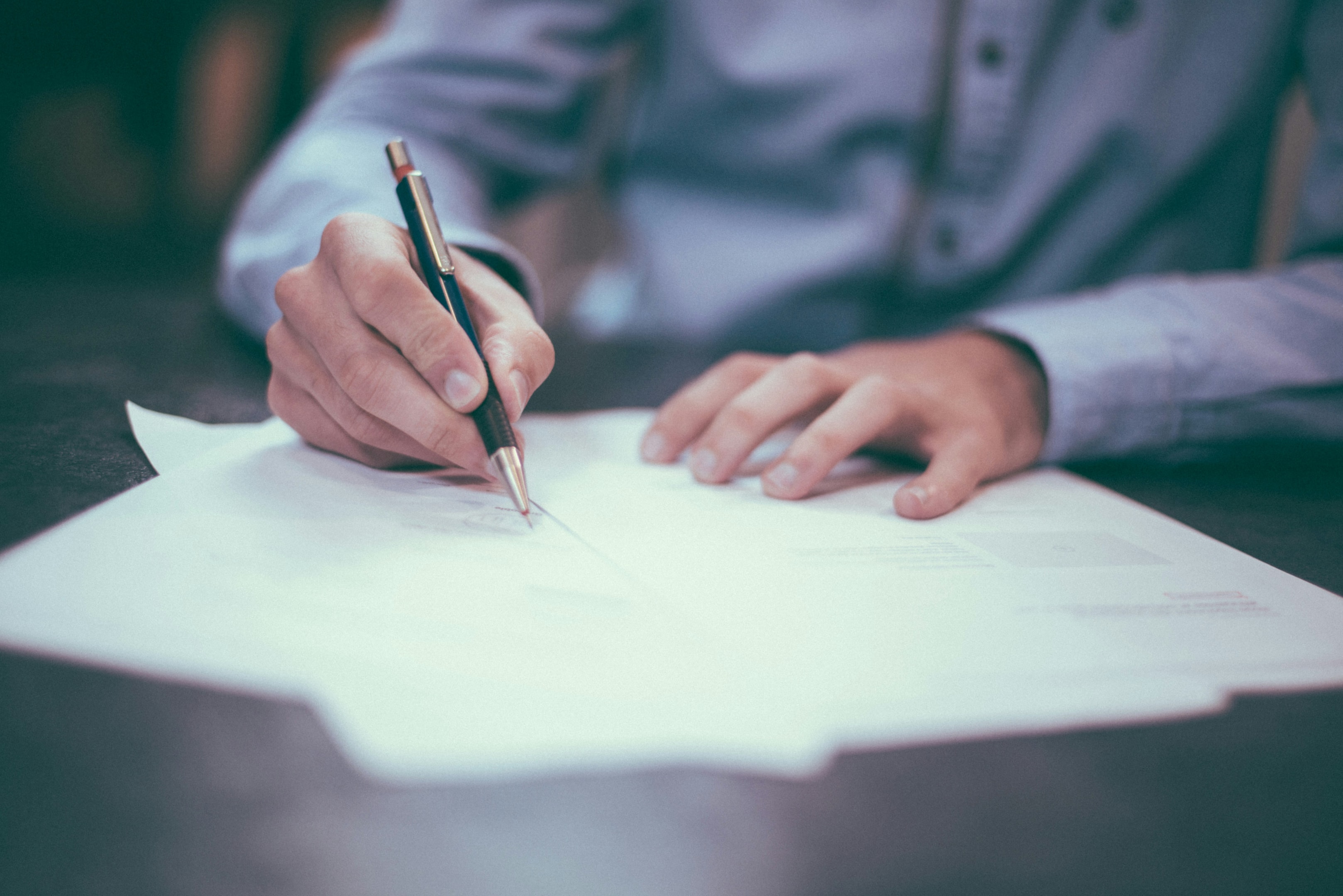 Real estate investor handwrites letter that will be sent to a motivated seller.