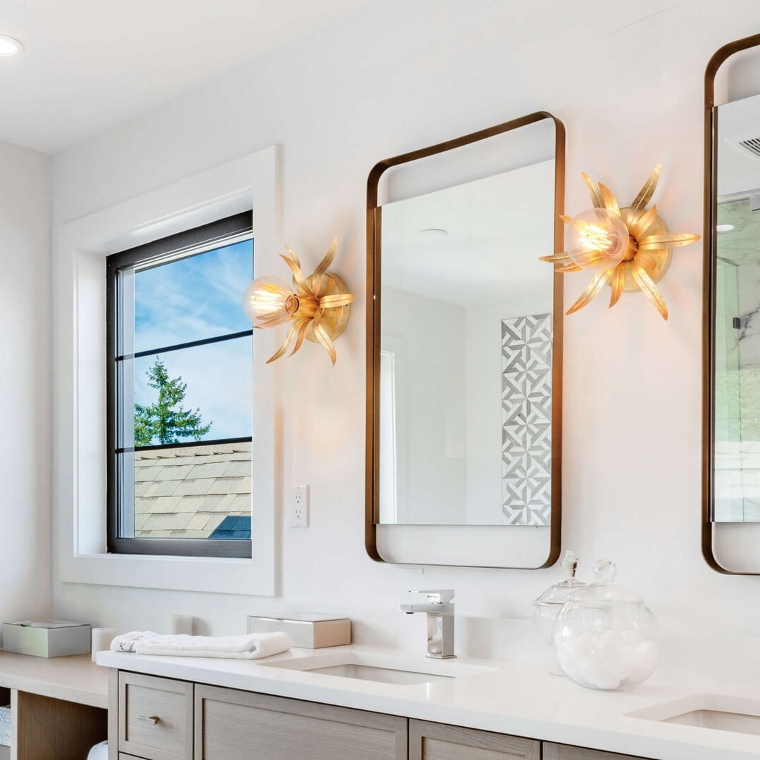 Contemporary bathroom with decorative wall lights and double mirrors, featuring a creative mix of bold lighting ideas and soft natural tones.