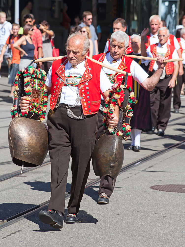 Swiss man carrying cowbells in traditional clothing