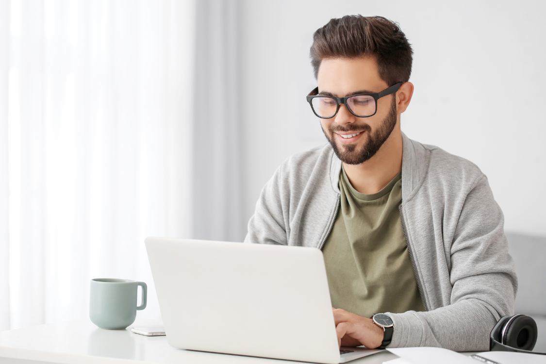 Business owner managing their business sale independently using a laptop without hiring a broker