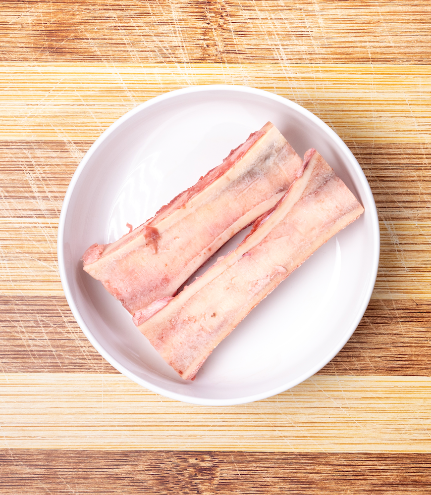 A close-up image of raw meaty bones, an essential part of the barf diet for dogs