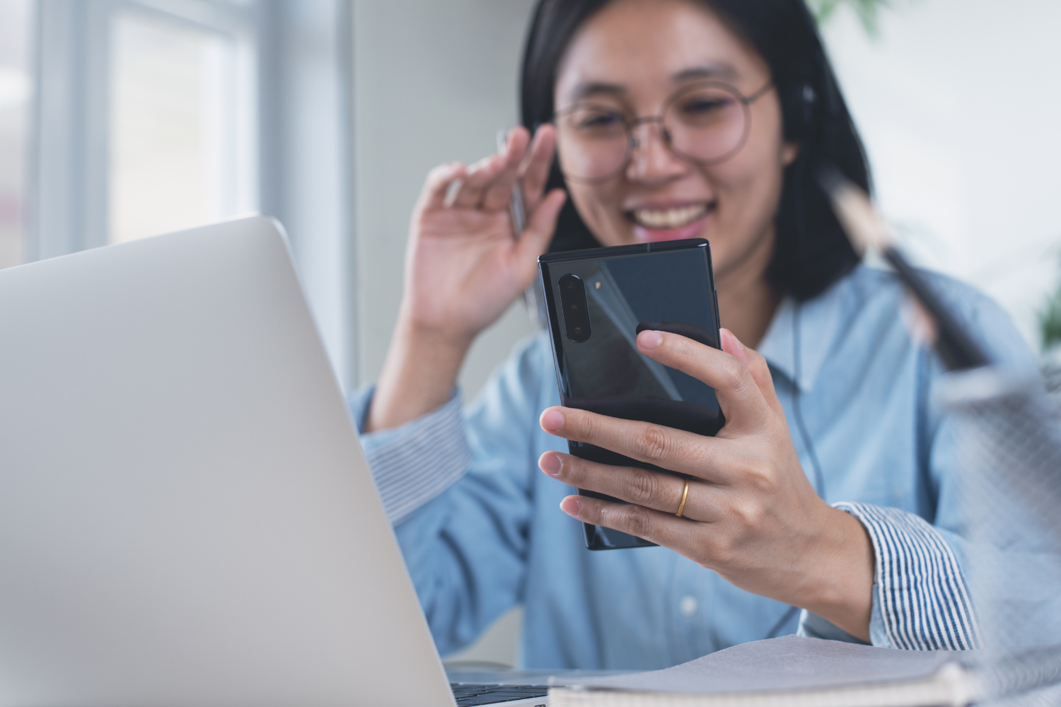 Woman smiling on smartphone.