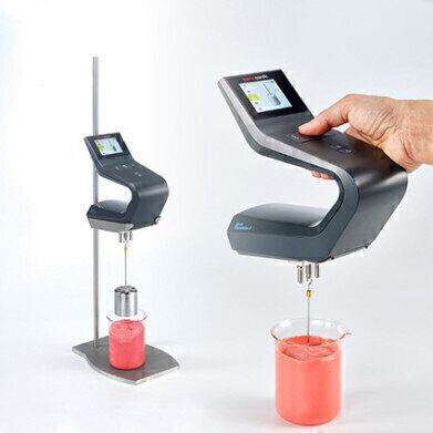 Portable viscometer being used in an industrial setting
