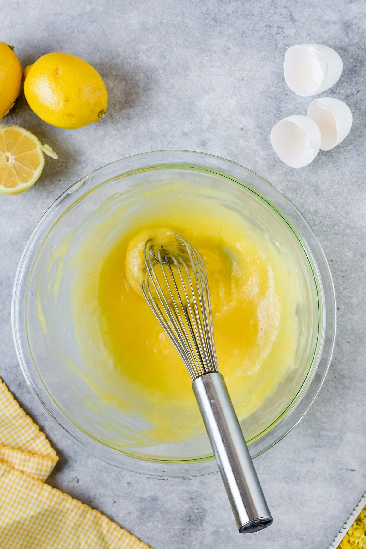 lemon curd in bowl with a whisk