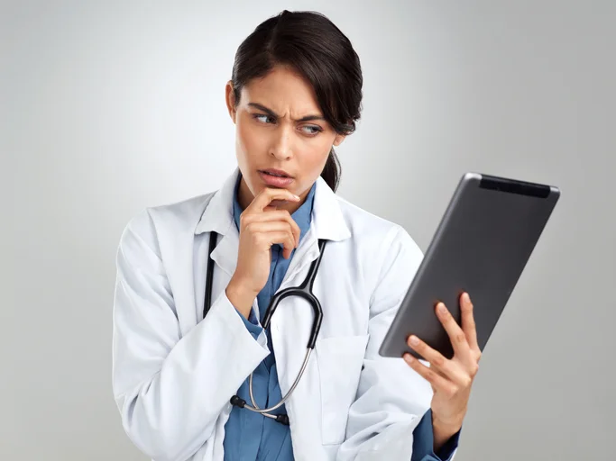A doctor holding a digital tablet