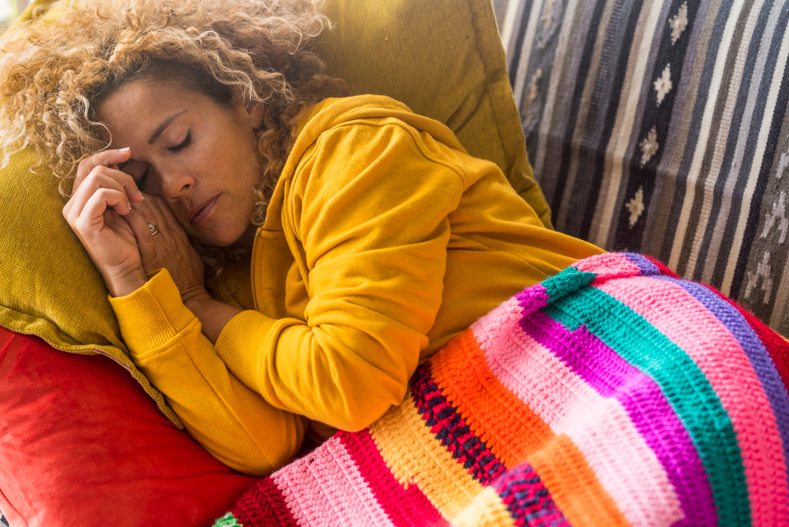 a woman who is resting after her tooth extraction to reduce healing time
