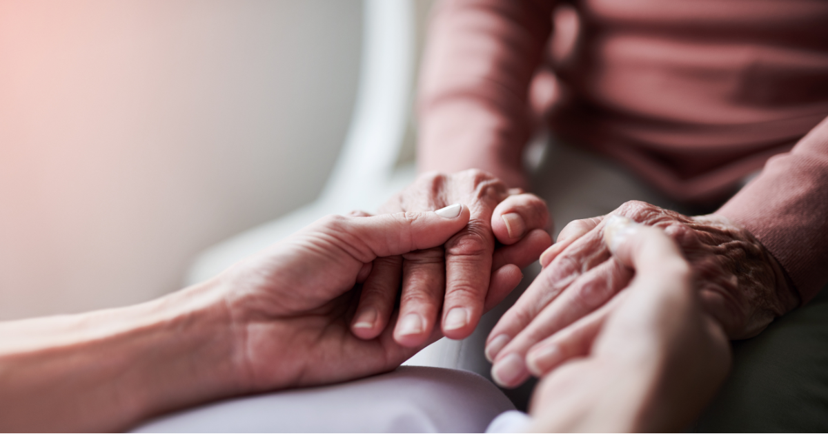 holding hands of a patient to show compassion and support