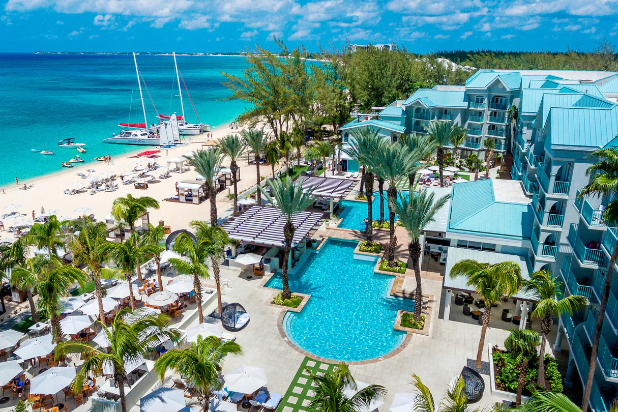 westin grand cayman resort overlooking white sand beaches and teal blue water with catamarans docked