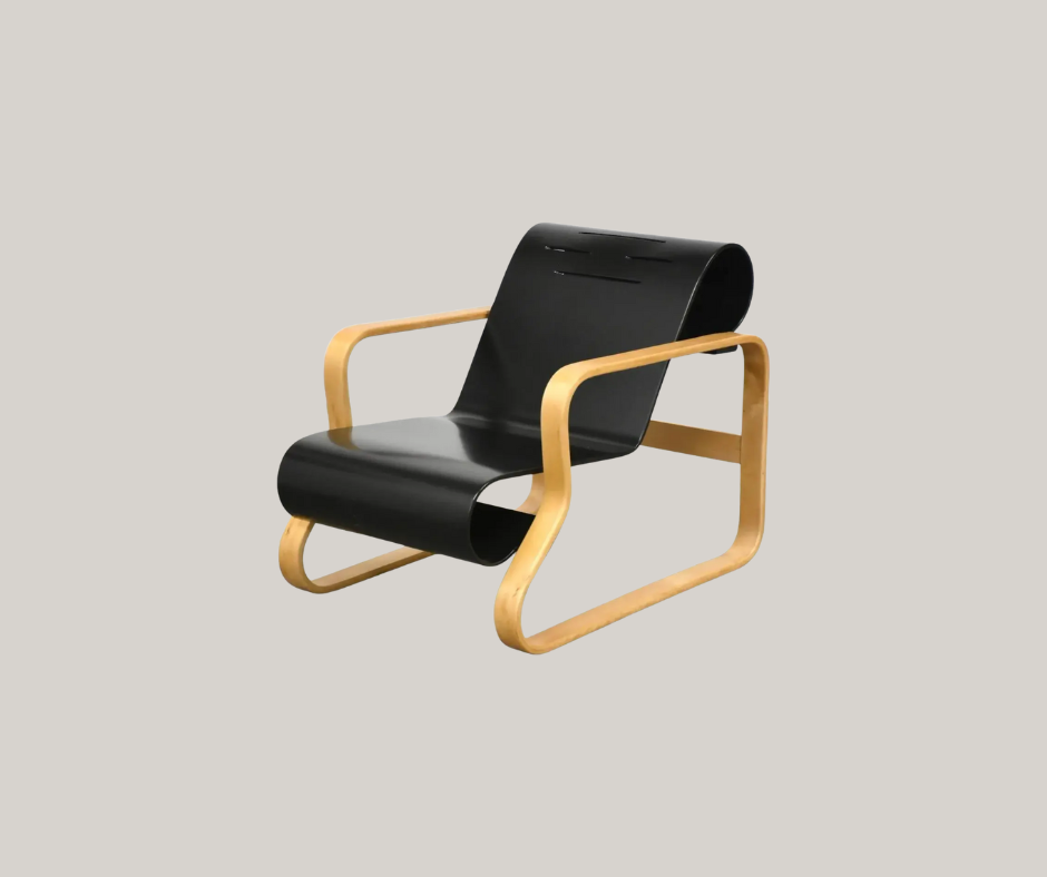 Black bent-plywood lounge chair with curved seat and back, supported by a light birch bent-wood frame.