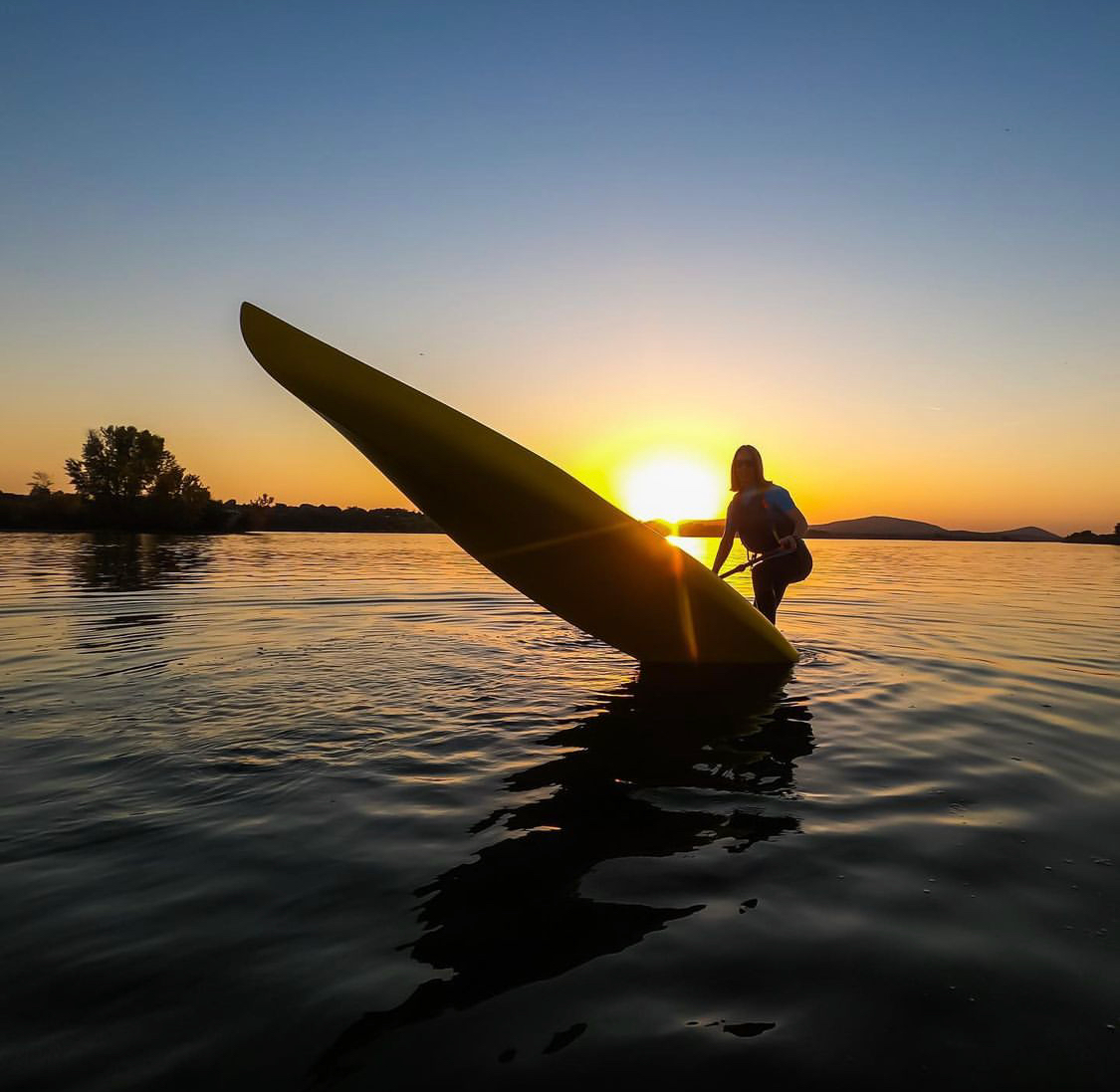 stand up paddle board at sunset