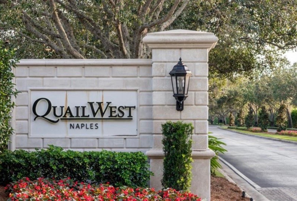 An aerial view showcases the stunning luxury estate homes in Quail West, highlighting the picturesque golf course and serene lake views. This tranquil and upscale neighborhood is known for its exceptional double lot estates and luxury living amenities, making it a desirable destination for those seeking a golf community lifestyle.