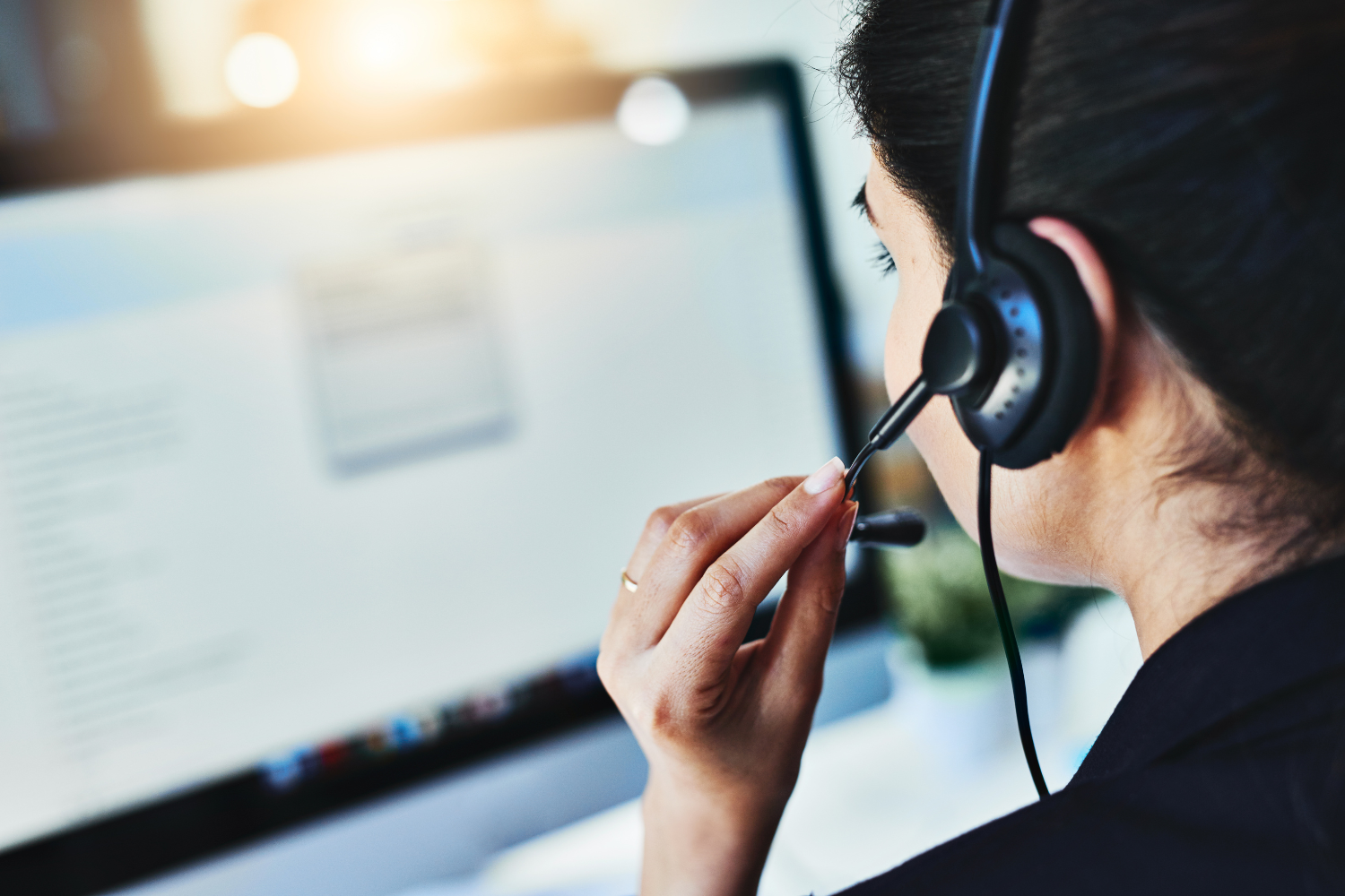 Call center agent speaking through a headphone.