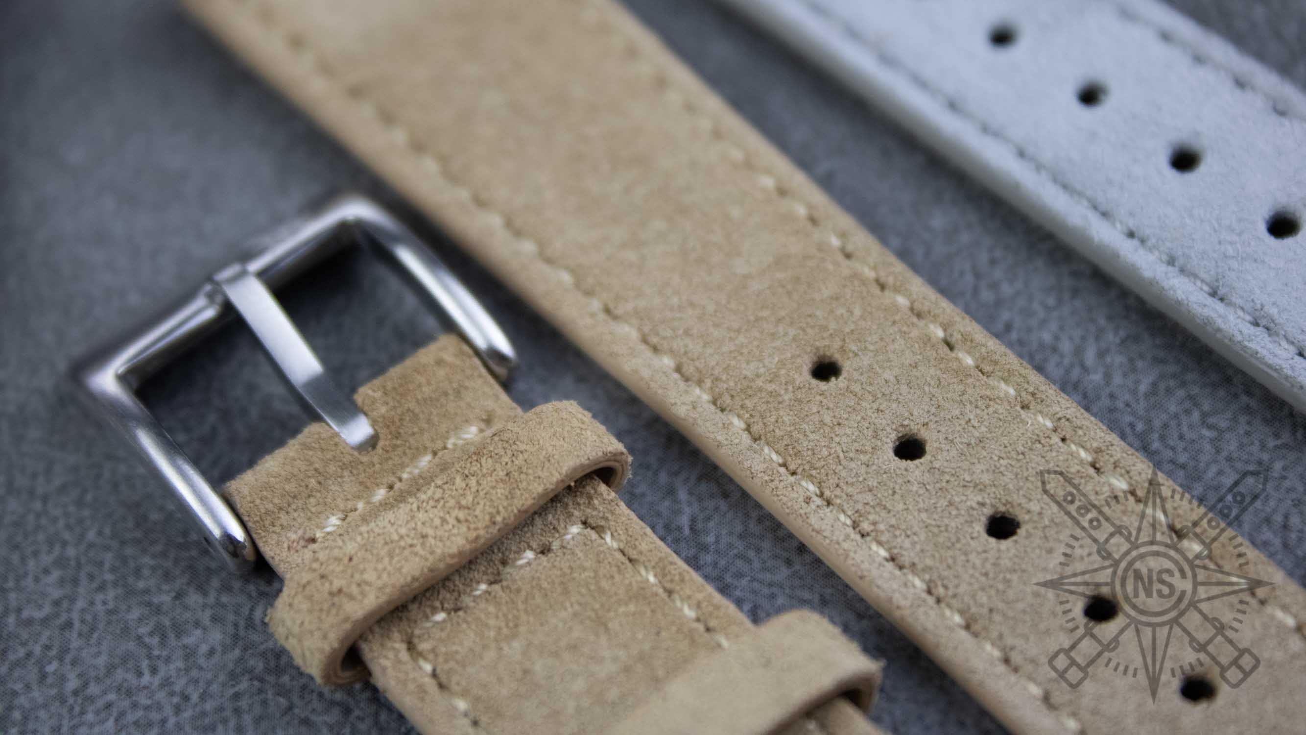 A detailed view of an Italian leather tannery showcases traditional vegetable tanning vats filled with rich oak bark extracts, highlighting the craftsmanship behind high-quality suede leather. This scene emphasizes the soft texture and luxurious feel of suede, essential for creating elegant watch straps and bands.