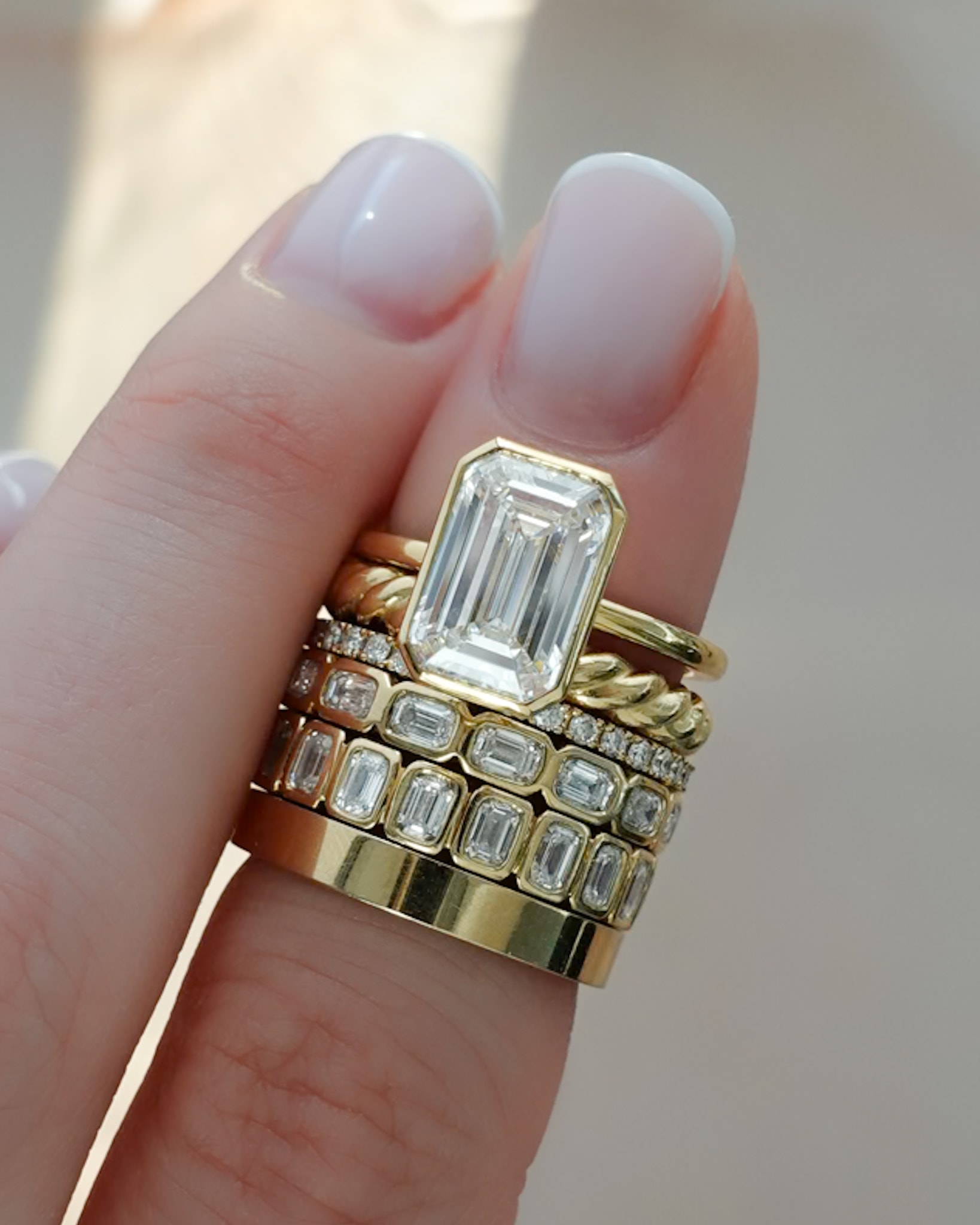 Stack  our Penumbra Bezel Set Engagement Ring With Emerald Cut