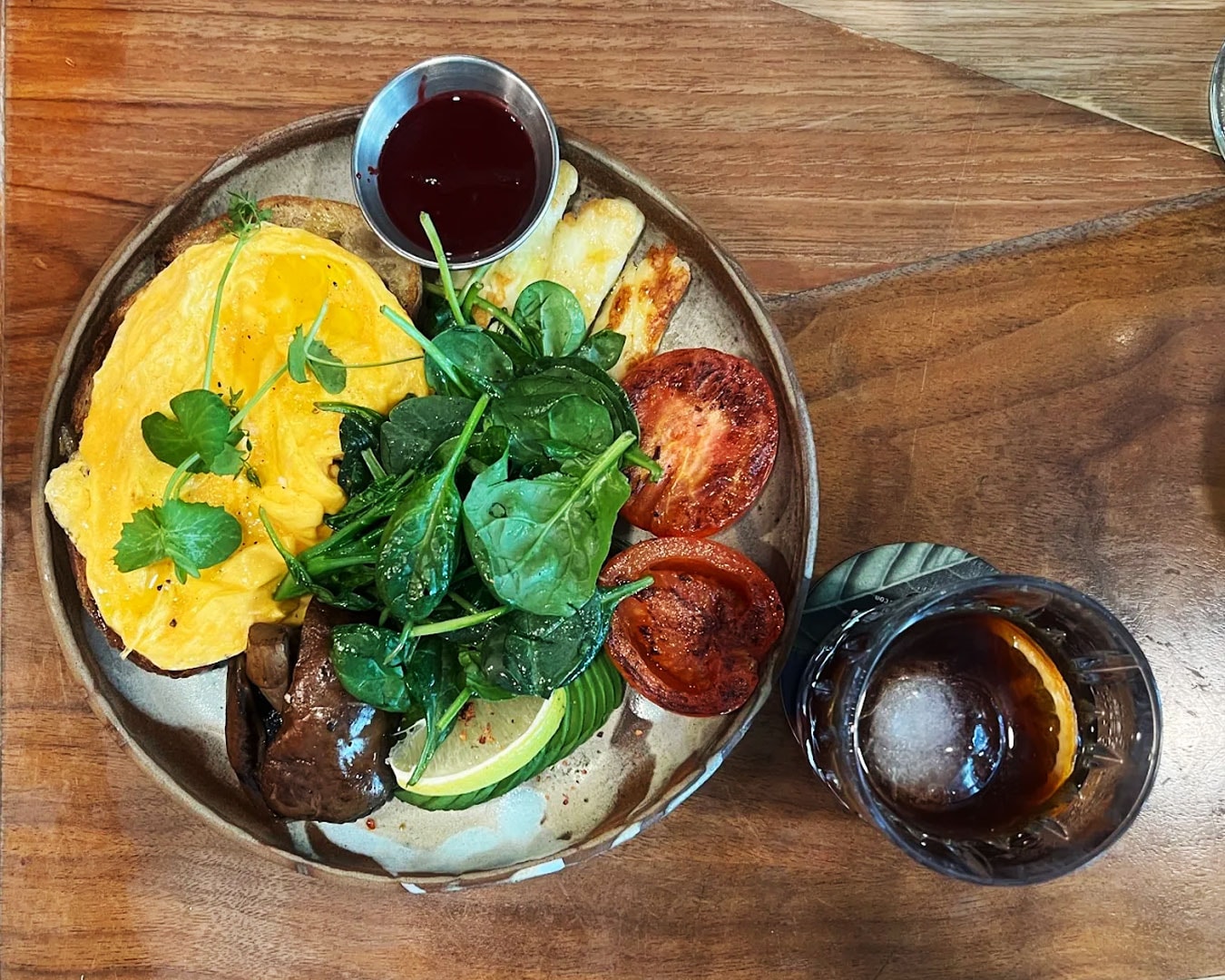 A traditional English-style breakfast with sausages, eggs, grilled tomatoes, and toast, served neatly on a white plate for a timeless look.