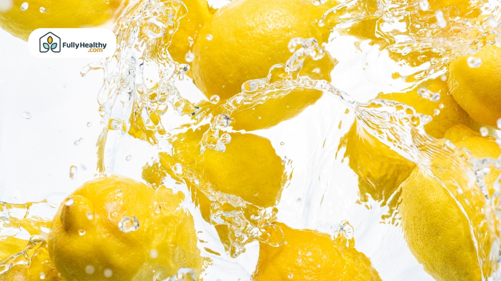 Fresh lemons splashing in clear water on a white background
