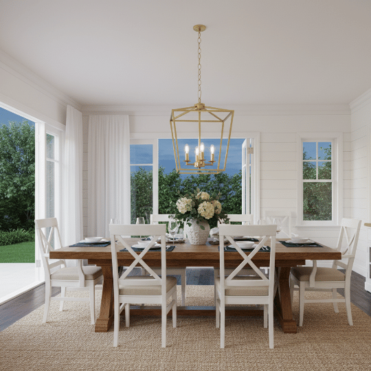 Gold lantern-style chandelier hanging above a farmhouse dining table.