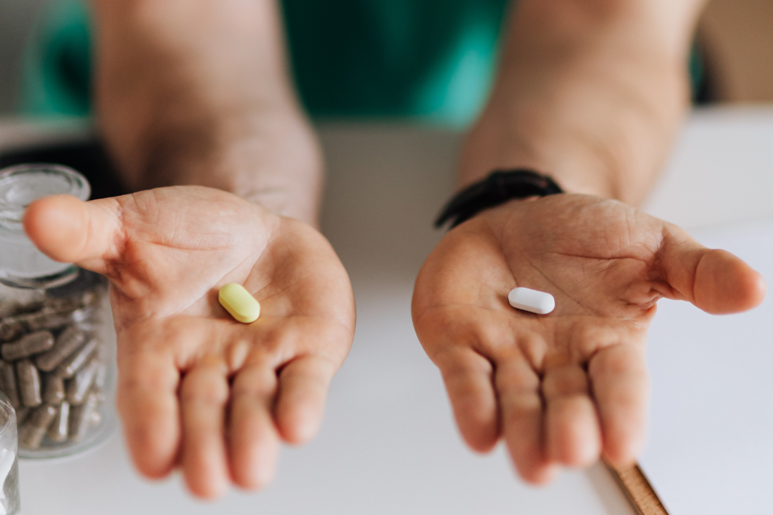 Person comparing two different supplement tablets for private label product selection