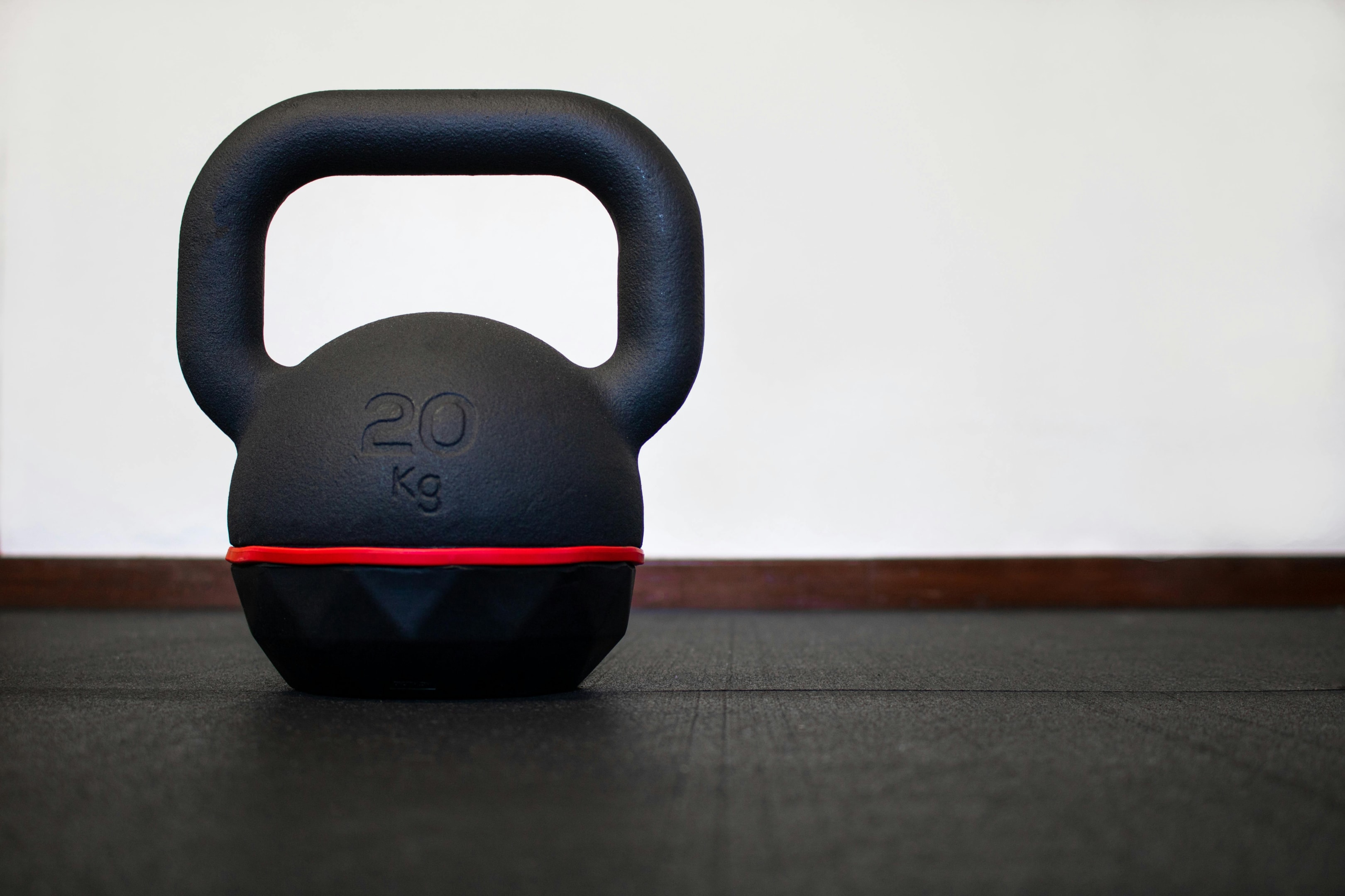 Photo by Marta Nogueira: https://www.pexels.com/photo/close-up-of-20kg-black-kettlebell-isolated-on-the-floor-at-the-gym-bodybuilding-and-fitness-equipment-on-a-white-background-with-empty-space-for-text-and-left-alignment-17092538/