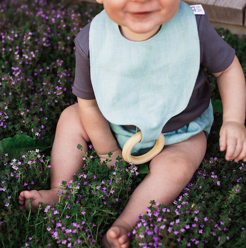 baby boy sitting wearing a linen bib