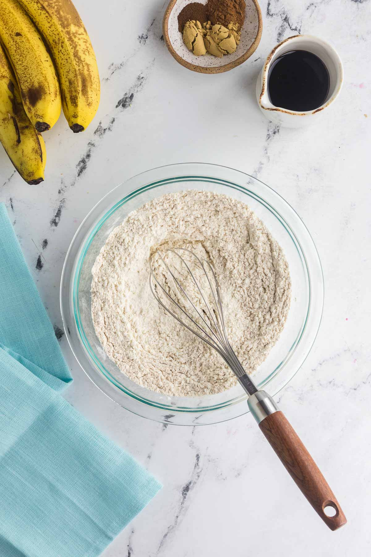 banana gingerbread dry ingredients in medium bowl with whisk