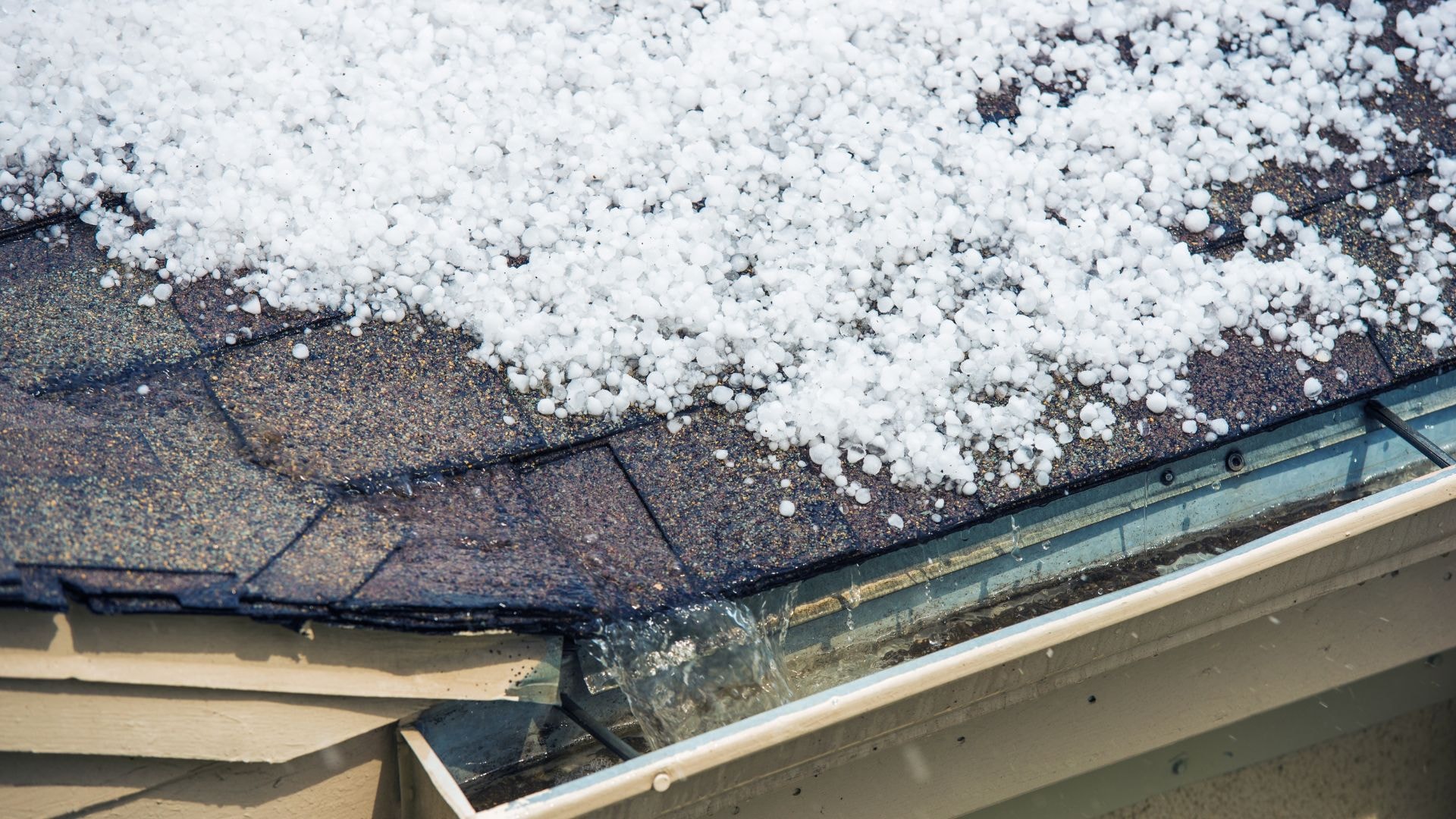 Rental property in Toledo showing winter damage with ice buildup and roof strain from heavy snow.