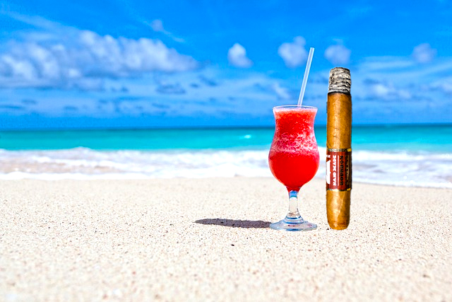 Enjoying your favorite cocktail, beach view and a Macanudo Cigar