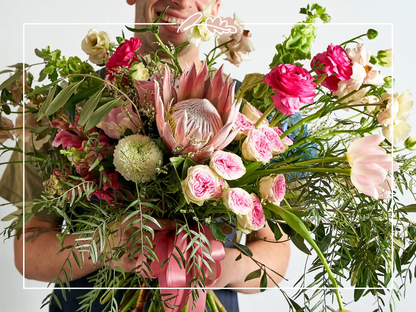 Man holding a large, colorful bouquet of flowers - Fabulous Flowers and Gifts