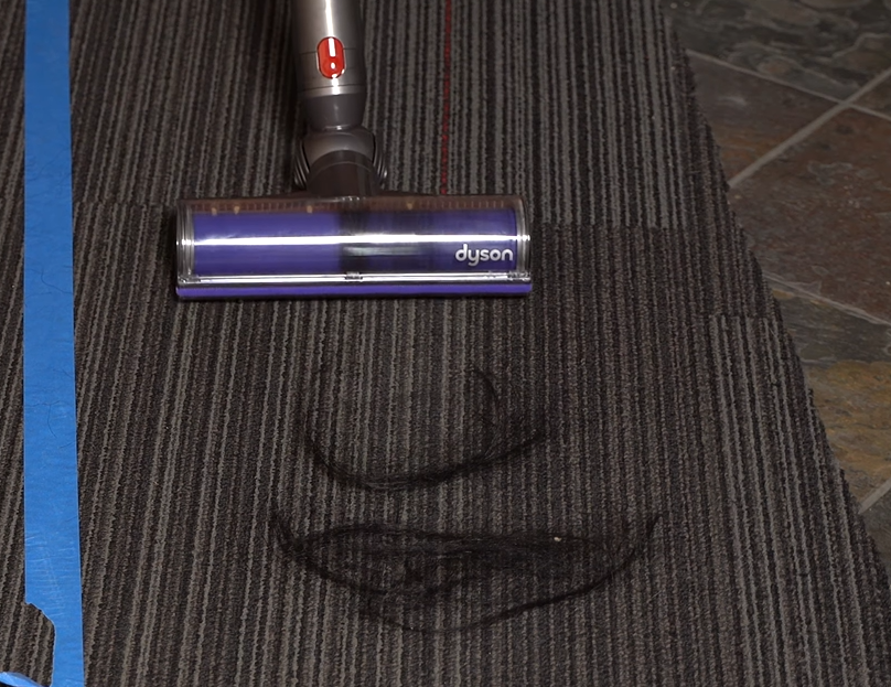 Dyson V8 vacuum picking up hair on carpet