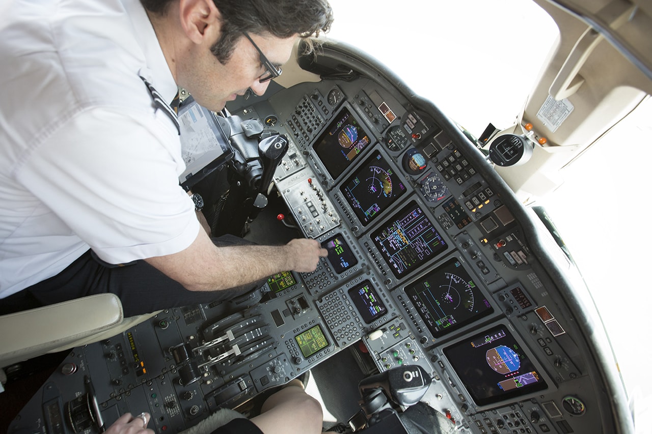 pilot adjusting altimeter before takeoff