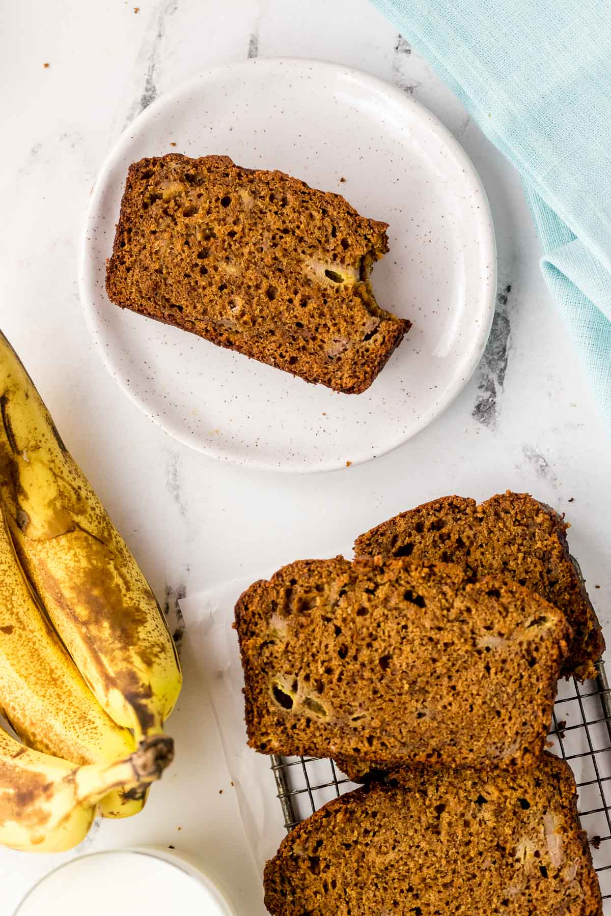 slice of banana gingerbread on a plate on a wire rack