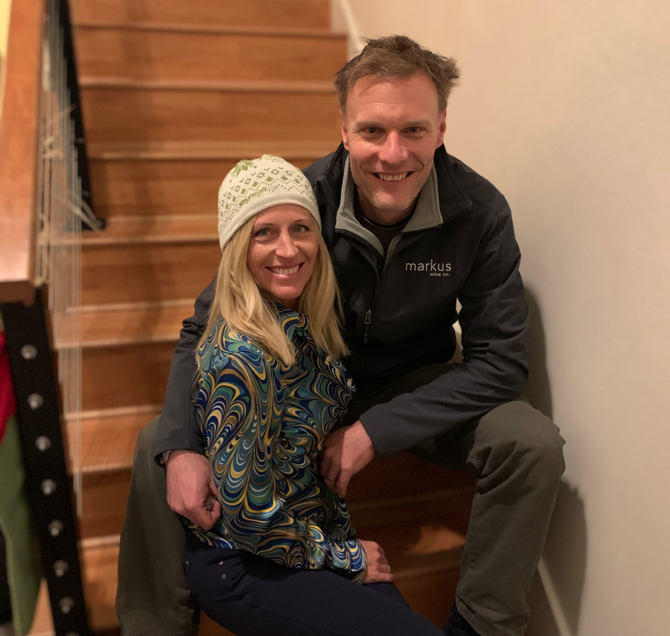 winemaker and his wife sitting on stairs