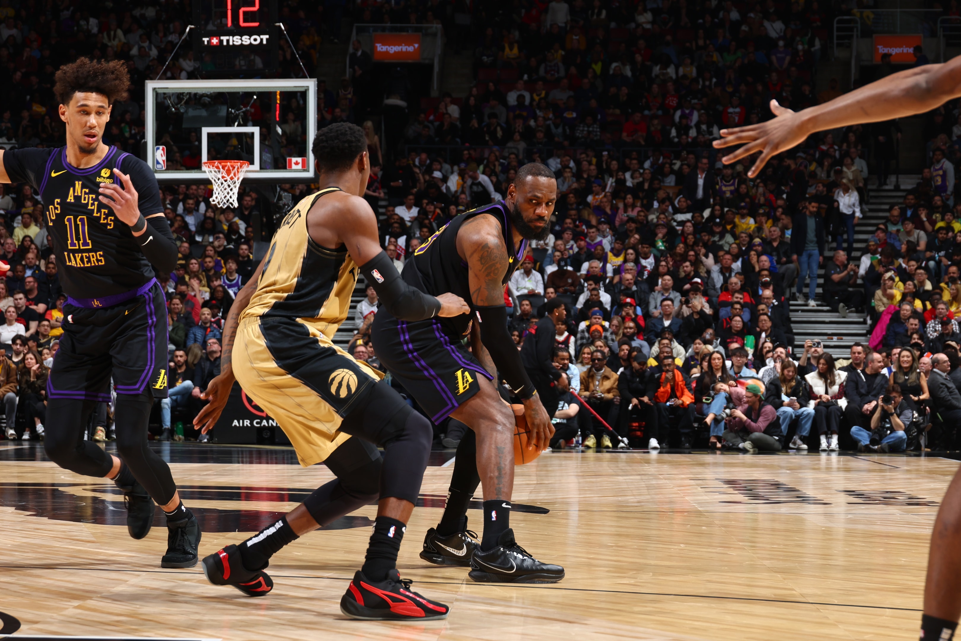  LeBron James of the Los Angeles Lakers handles the ball during the game against the Toronto Raptors at Scotiabank Arena in Toronto, Ontario, Canada.