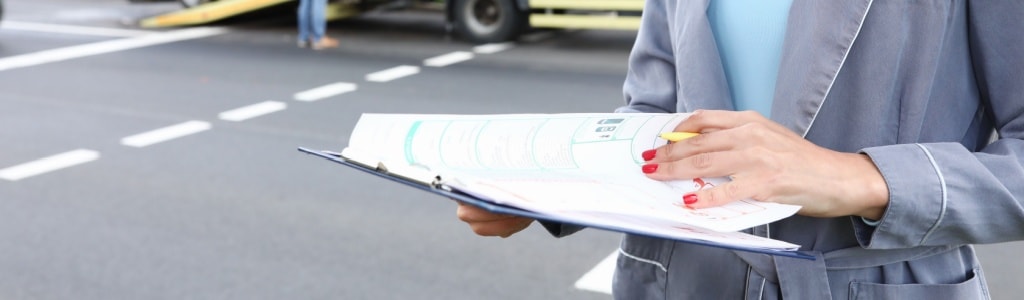 An image showing a person gathering evidence at a truck accident scene.