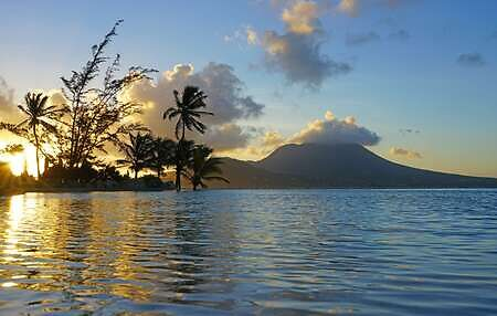 Stunning St. Kitts Sunsets, Day view of the Nevis Peak volcano across the water from St Kitts