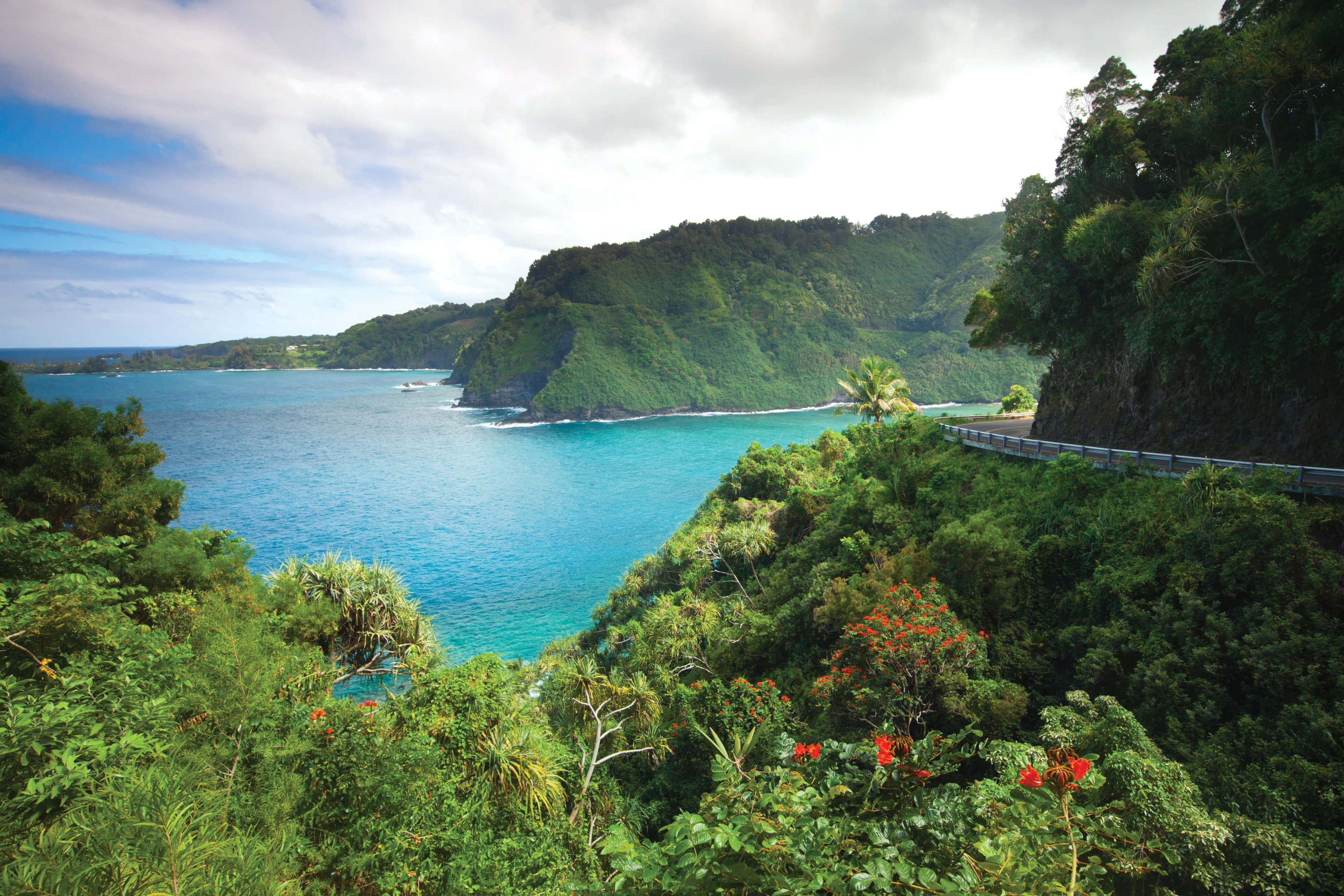 turquoise blue water with lush green hills all around