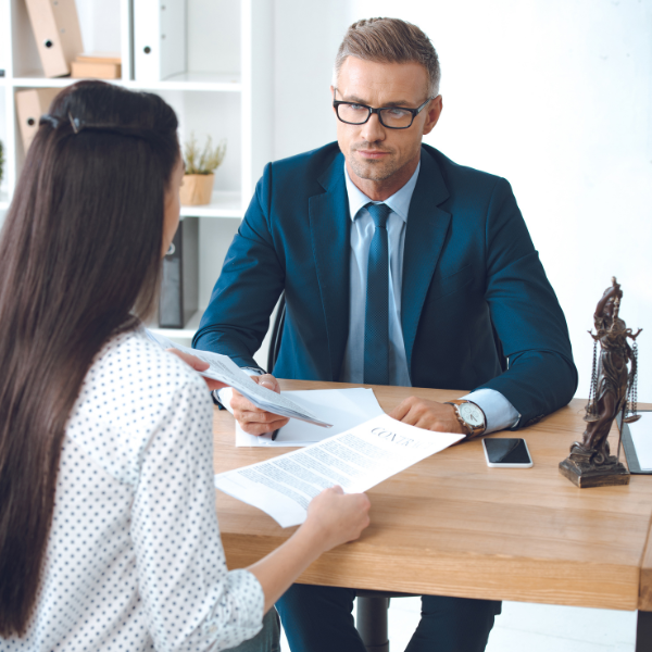 Image showing a person talking with a lawyer about a claim for their Georgia car accident case.