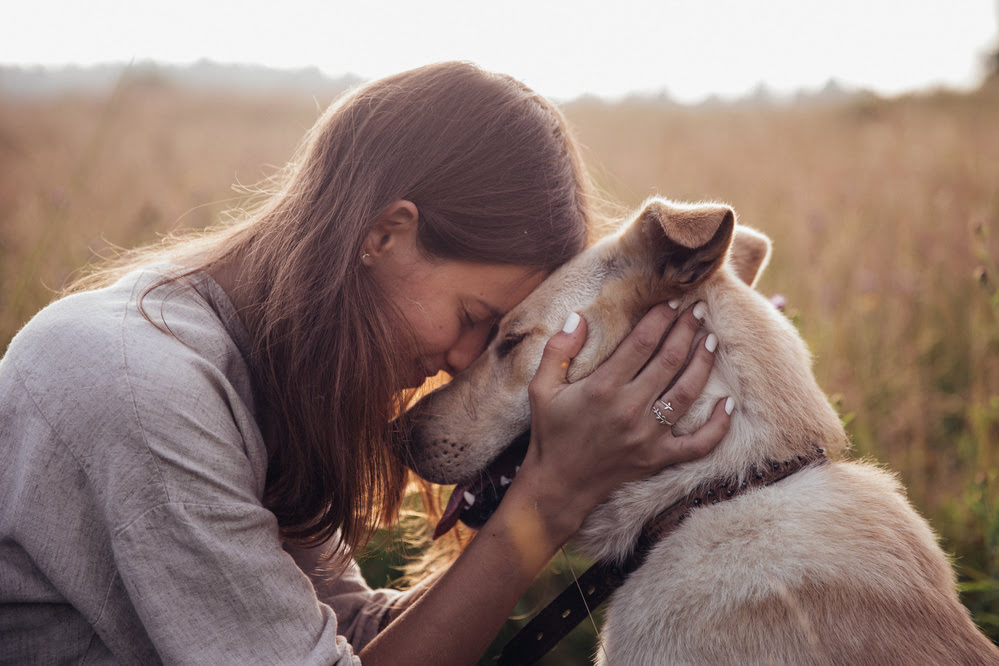 A woman embracing her dog