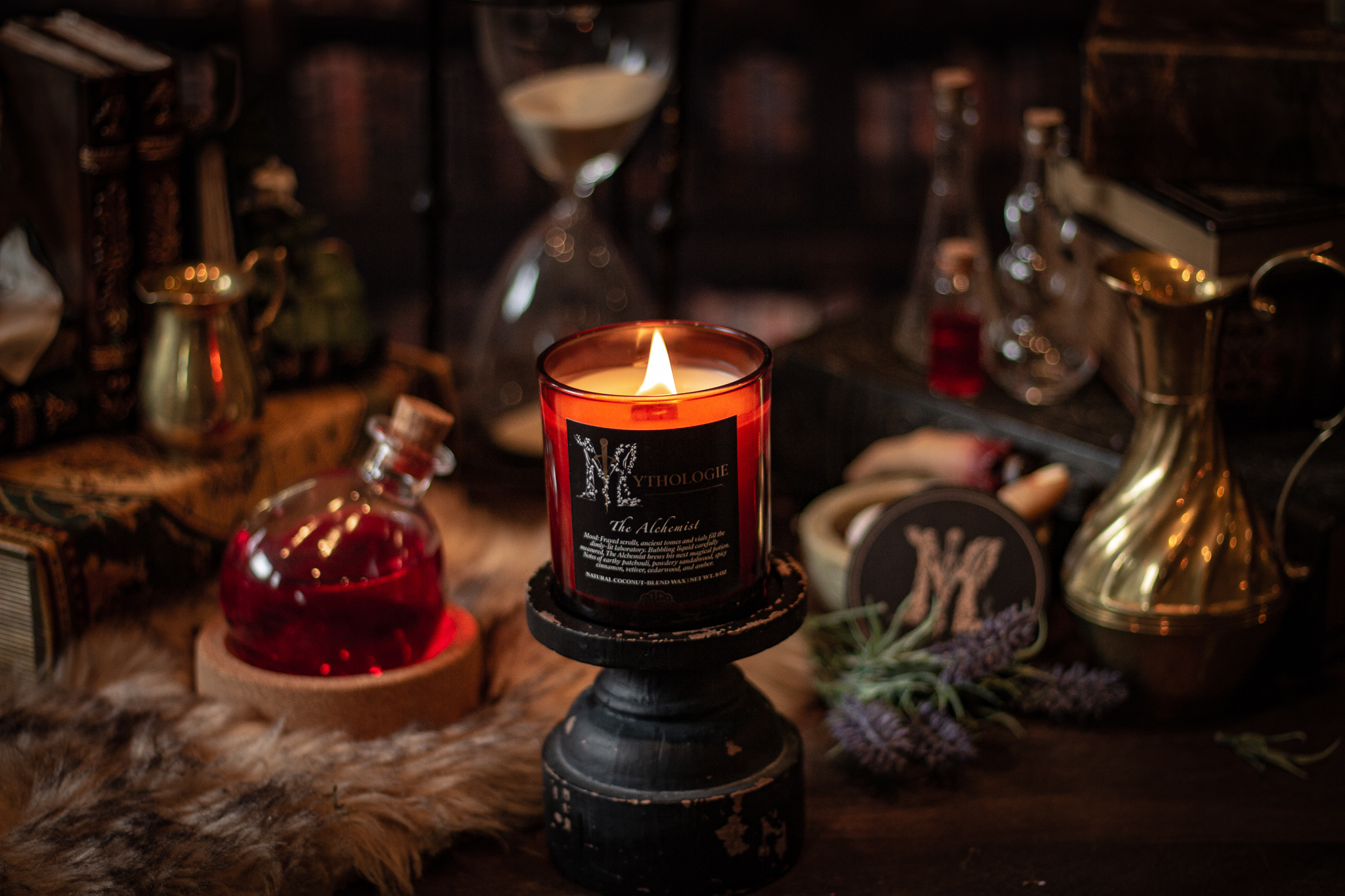 the alchemist candle in a lab of essential oil vials, patchouli, sandalwood, cinnamon scent