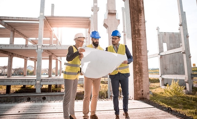 Contractors and managers looking at building plans.