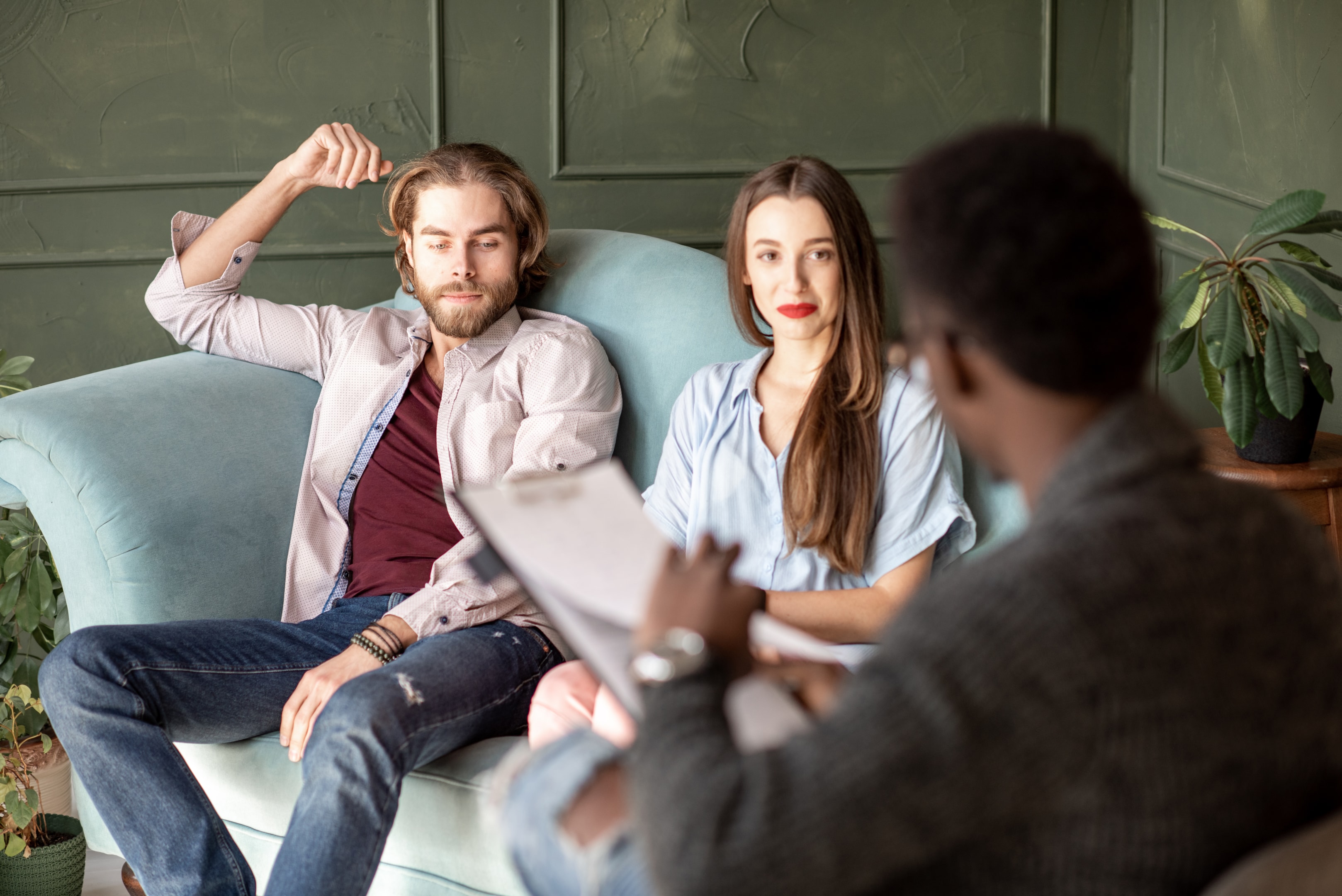 Image of A person sitting with a therapist, looking relieved as they have a breakthrough moment, illustrated by a lightbulb or moment of clarity visual element.