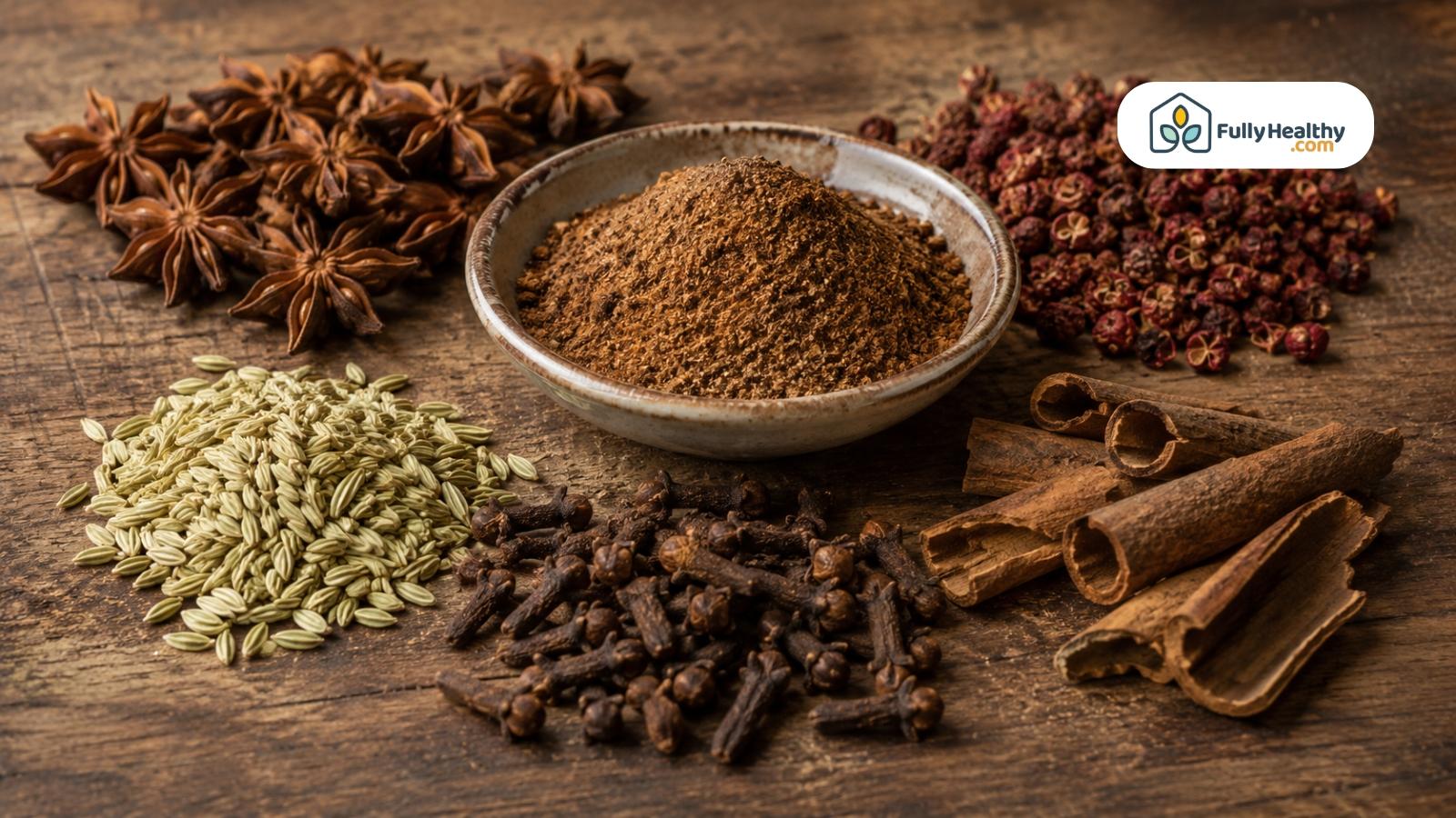 Chinese five-spice powder displayed with star anise, fennel, cloves, cinnamon, and peppercorns