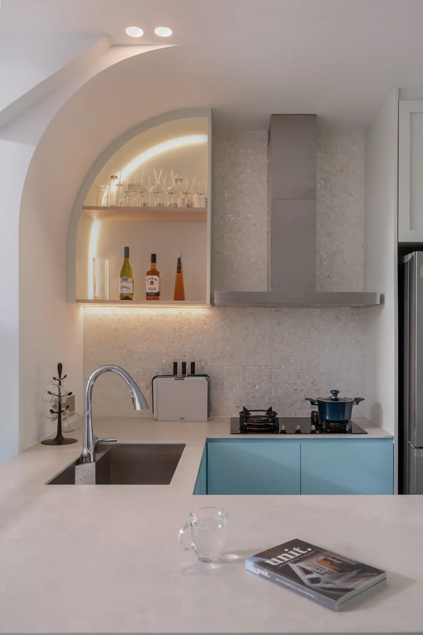 Contemporary kitchen designs with arched display shelf, LED strip lighting and pastel-blue base cabinets.