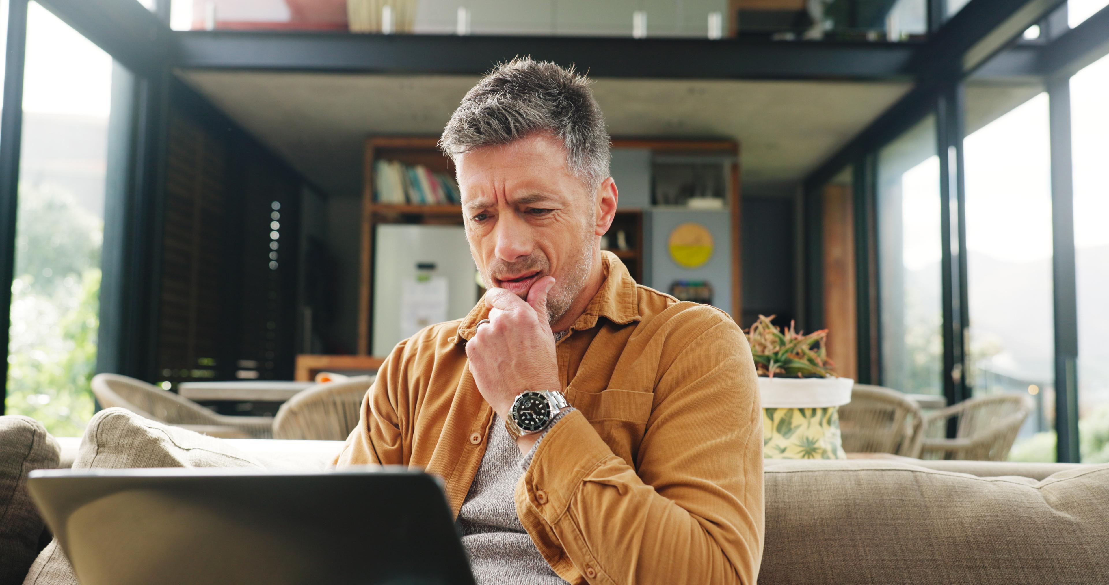 A man researches carefully considering all aspects of cocaine addiction treatment cost