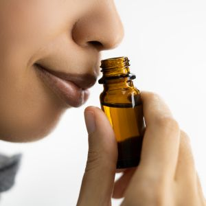 Woman smelling essential oils.