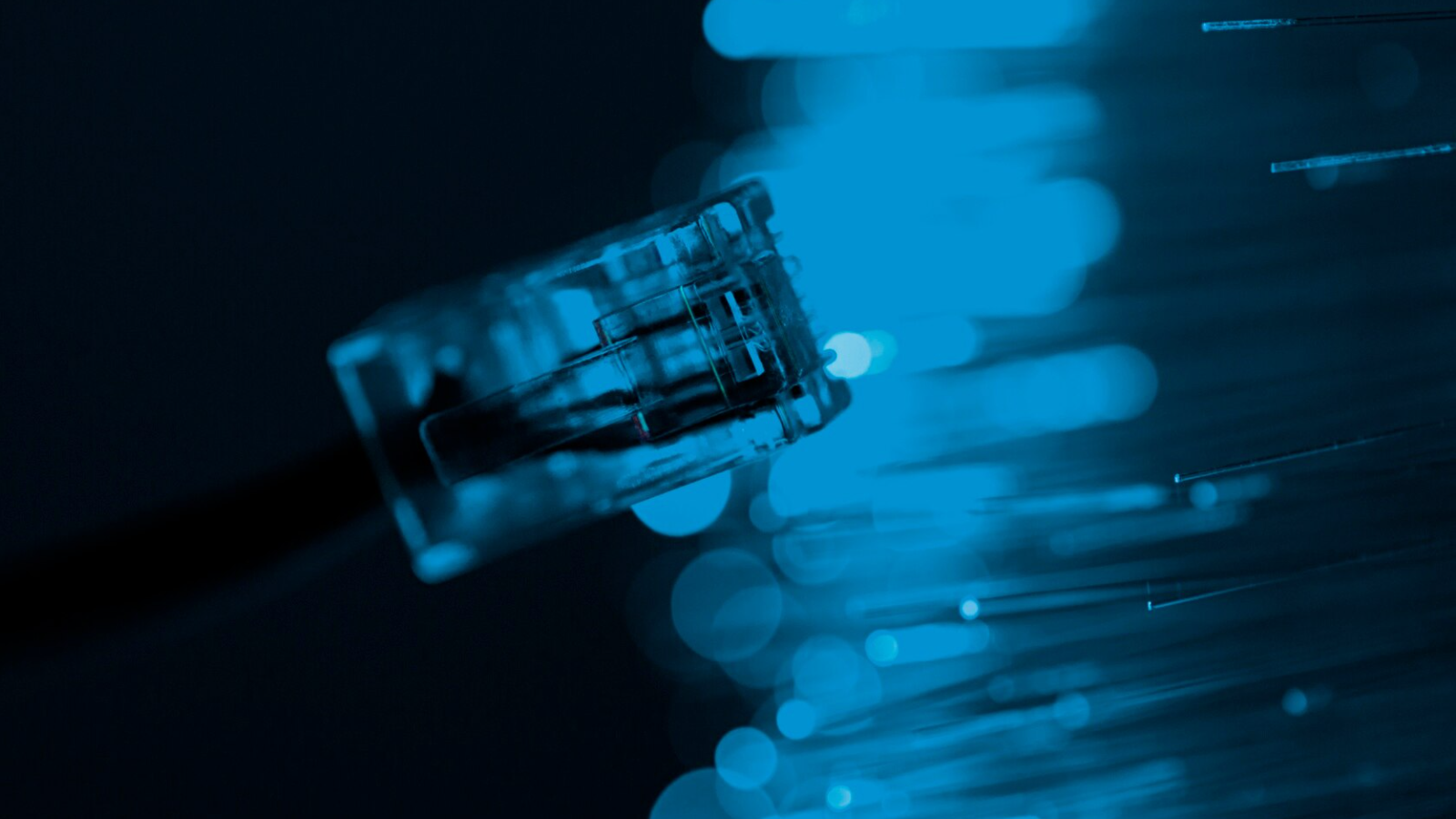 Ethernet connector near unlit Fiber strands, highlighting dark Fiber vs. lit Fiber for building private networks.