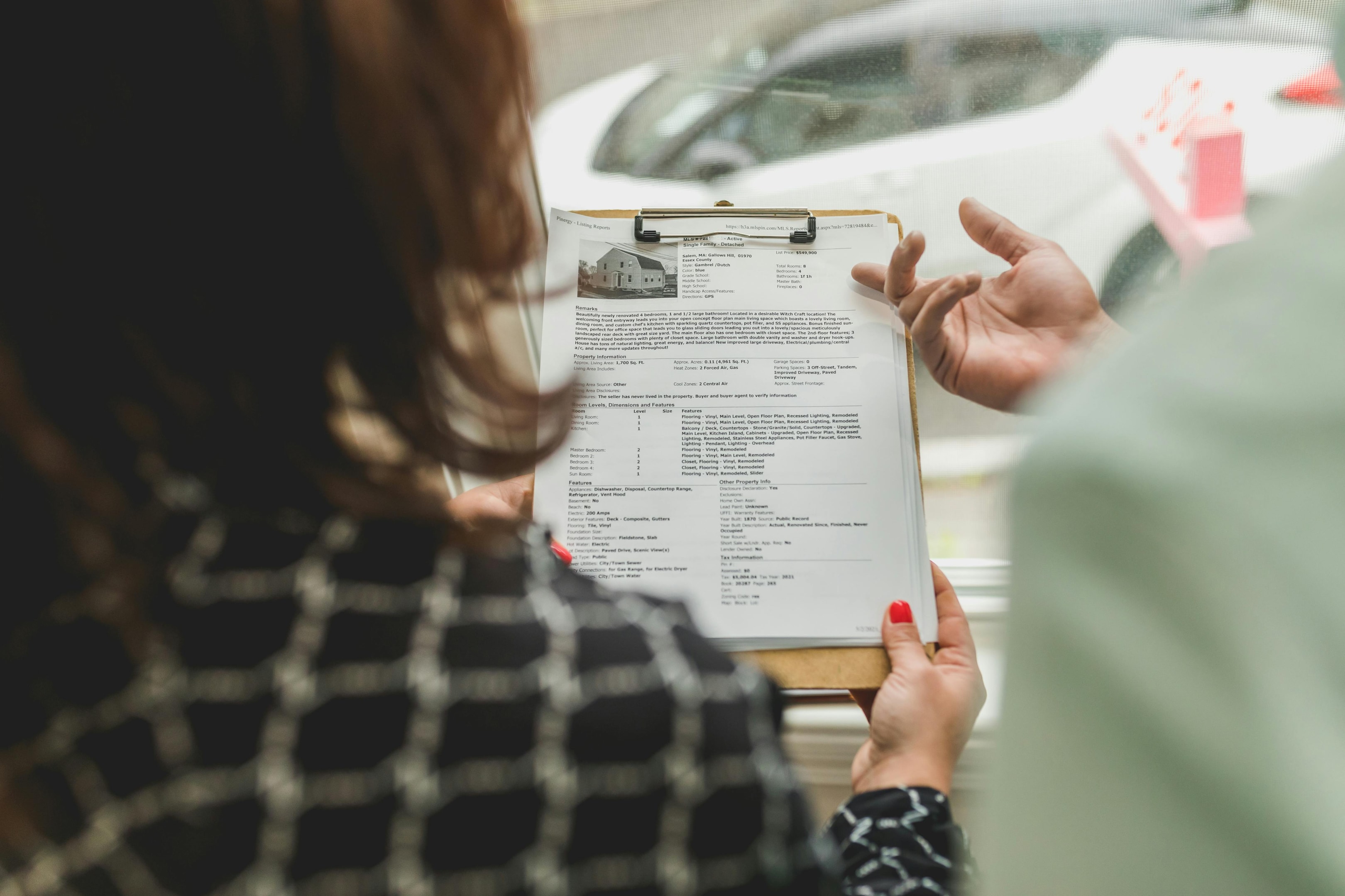 Real estate investors look over property information for a house going through bankruptcy.