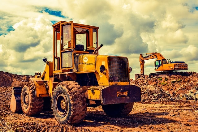 An attorney reviews workers compensation coverage options with a client injured working on heavy machinery.