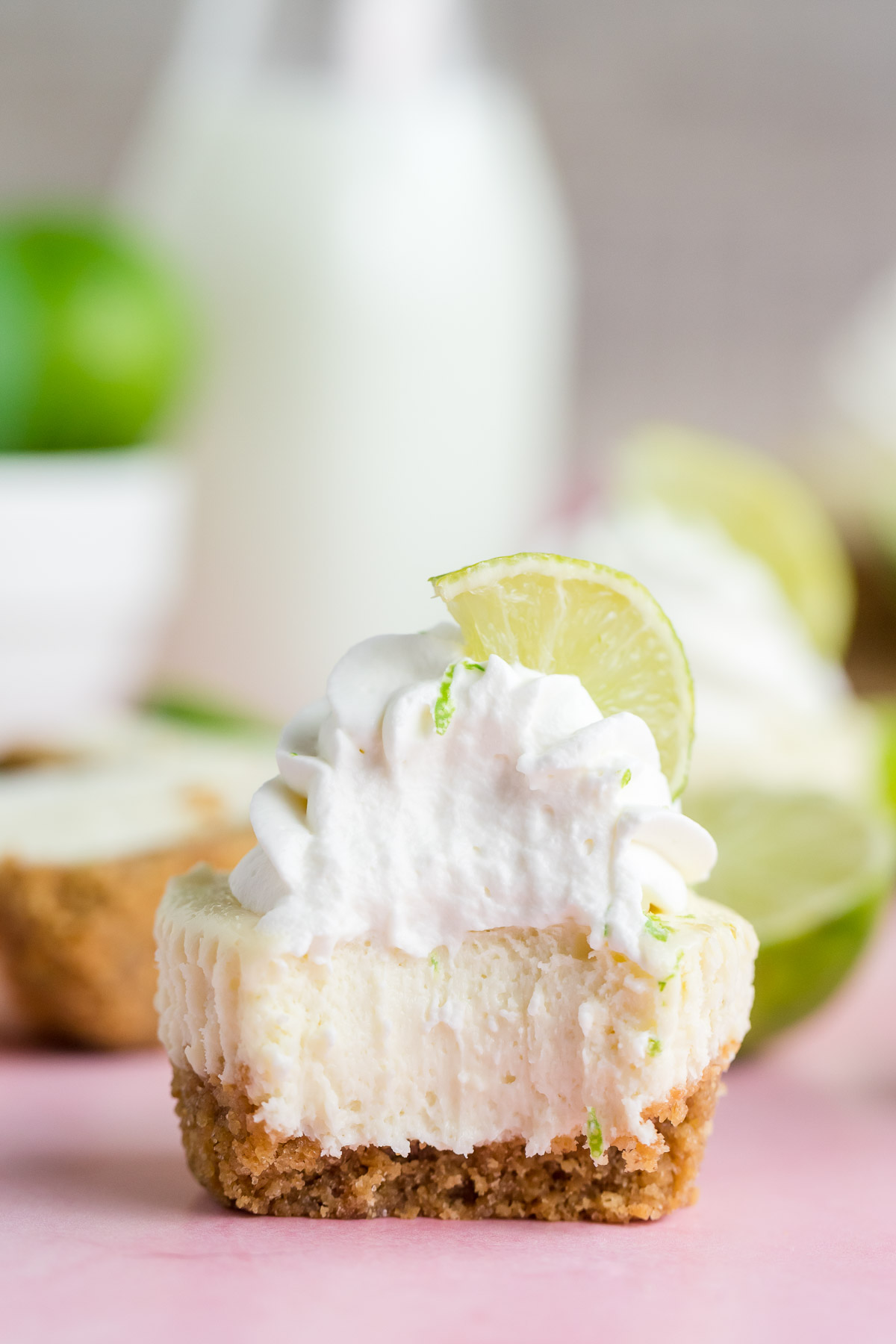 mini lime cheesecake with a bite taken out of it