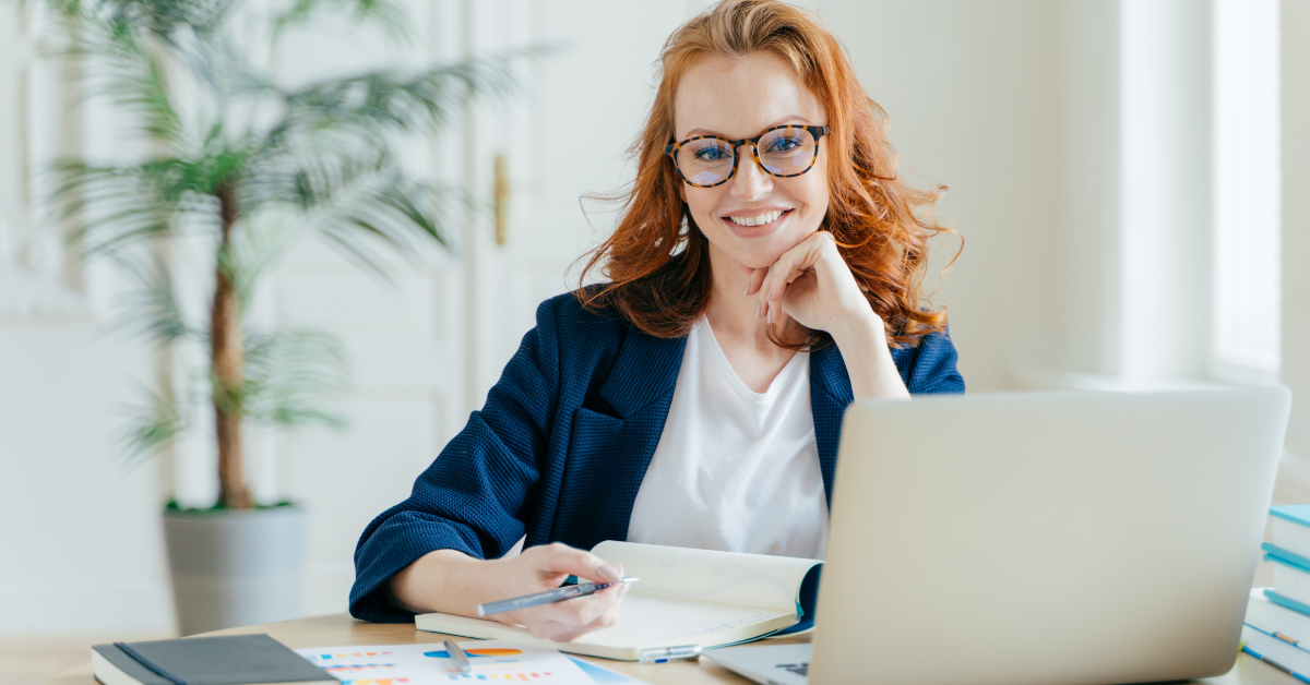 Confident woman working at her desk with a laptop and IRS tax forms while preparing a Form 1040 payment voucher.